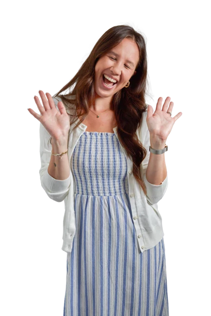 Sydney is wearing a beige jacket, blue jeans and white tank top as she smiles and looks off-camera.